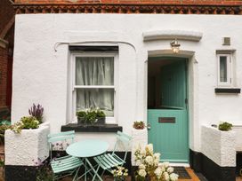 A front door with a window and seating at Tower View Cottage in Lympstone