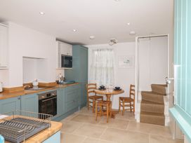A kitchen with a round table and chairs at Tower View Cottage in Lympstone