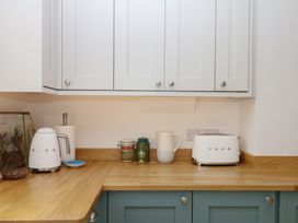 A kitchen with kettle and toaster on countertop at Tower View Cottage Lympstone