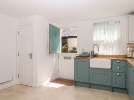 A kitchen with a sink and cabinets at Tower View Cottage in Lympstone