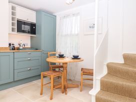 A kitchen with a dining table and chairs at Tower View Cottage in Lympstone