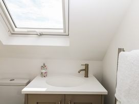 A bathroom with a sink and toilet at Tower View Cottage in Lympstone