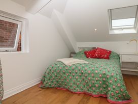 A bedroom with a bed and a desk at Tower View Cottage in Lympstone