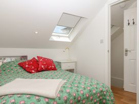 A bedroom with a bed and a nightstand at Tower View Cottage in Lympstone