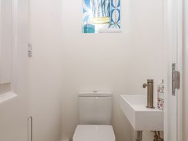 A bathroom with a toilet and sink at Tower View Cottage in Lympstone