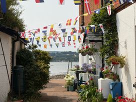 An outdoor pathway decorated with flags and flowers at Tower View Cottage in Lympstone