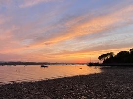 A shoreline with boats at sunset at Tower View Cottage in Lympstone