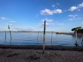 A view of water with boats and a pier at Tower View Cottage in Lympstone