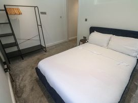 A bedroom with a bed and a hanger rack at The Lookout in Redruth