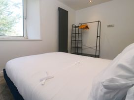 A bedroom with a bed and a clothing rack at The Lookout in Redruth
