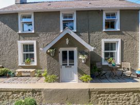 A house exterior with a door and seating area at St.Twynells Farm in Pembroke