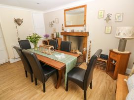 A dining room with a table and chairs at St.Twynells Farm in Pembroke