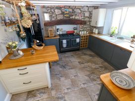 A kitchen with a stove and sink at St.Twynells Farm in Pembroke