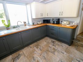 A kitchen with cabinets and appliances at St.Twynells Farm in Pembroke