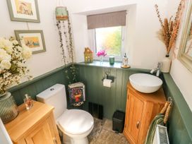 A bathroom with a toilet and sink at St.Twynells Farm in Pembroke