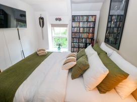 A bedroom with a bed and a television at St.Twynells Farm in Pembroke