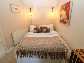 A bedroom with a bed and artwork at St.Twynells Farm in Pembroke