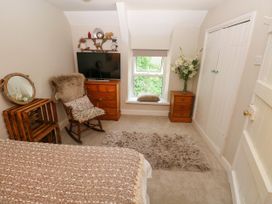 A bedroom with a bed and television at St.Twynells Farm in Pembroke