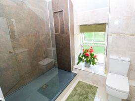 A bathroom with a shower and toilet at St.Twynells Farm in Pembroke