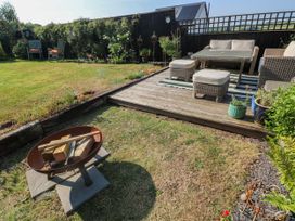 A garden with outdoor seating and a fire pit at St.Twynells Farm in Pembroke