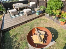 A garden with seating area and fire pit at St.Twynells Farm in Pembroke