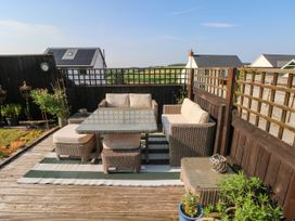 An outdoor seating area with a table and chairs at St.Twynells Farm Pembroke
