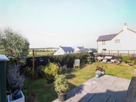 A garden with furniture and plants at St.Twynells Farm in Pembroke