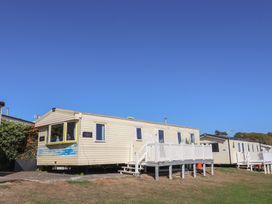 A mobile home with a deck and steps at Beech Walk 3 in Sandy Bay, Exmouth