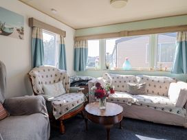 A living room with sofa and coffee table at Beech Walk 3 Sandy Bay, Exmouth