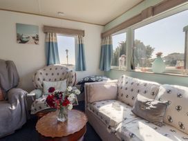 A living room with a sofa and armchair at Beech Walk 3 Sandy Bay, Exmouth