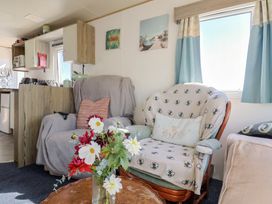 A living room with a sofa and coffee table at Beech Walk 3 Sandy Bay, Exmouth