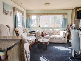 A living room with a sofa and armchairs at Beech Walk 3 in Sandy Bay, Exmouth
