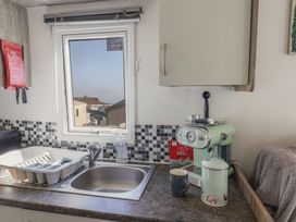 A kitchen with a sink and coffee machine at Beech Walk 3 Sandy Bay, Exmouth
