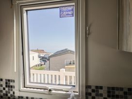 A window view showing houses and ocean at Beech Walk 3 Sandy Bay, Exmouth
