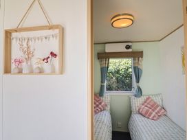 A bedroom with twin beds and a window at Beech Walk 3 Sandy Bay Exmouth