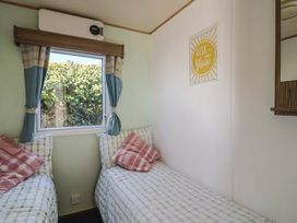 A bedroom with two beds and a window at Beech Walk 3 Sandy Bay, Exmouth