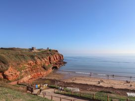 A beach with people near the ocean at Beech Walk 3 Sandy Bay, Exmouth