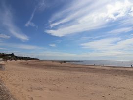 A beach with sand and ocean at Beech Walk 3 Sandy Bay, Exmouth