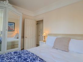 A bedroom with a bed and a lamp at 2 St. Michaels House Lyme Regis