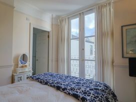 A bedroom with a bed and a mirror at 2 St. Michaels House in Lyme Regis
