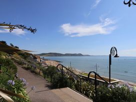 A view of the beach and sea with plants along the pathway at 2 St. Michaels House in Lyme Regis