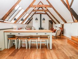 A living room with a dining table and chairs at The Hayloft at Manaton