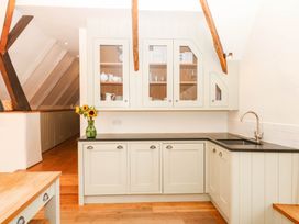 A modern kitchen with cabinets and a sink at The Hayloft at Manaton