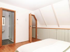 A bedroom with a shower and toilet at The Hayloft at Manaton