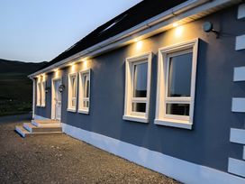An exterior view of a house with windows and a door at Sliabh League Mountain Lodge, TEILEANN near Kilcar, County Donegal