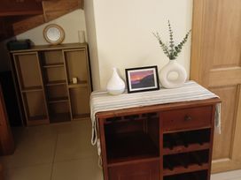 A dining table with a vase and photo at Sliabh League Mountain Lodge, TEILEANN near Kilcar, County Donegal