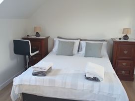 A bedroom with a bed and nightstands at Sliabh League Mountain Lodge TEILEANN near Kilcar, County Donegal