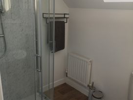 A bathroom with a shower and towel rack at Sliabh League Mountain Lodge TEILEANN near Kilcar, County Donegal