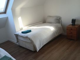 A bedroom with a bed and a bedside table at Sliabh League Mountain Lodge TEILEANN near Kilcar, County Donegal