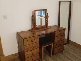 A vanity table with a mirror in a bedroom at Sliabh League Mountain Lodge TEILEANN near Kilcar, County Donegal